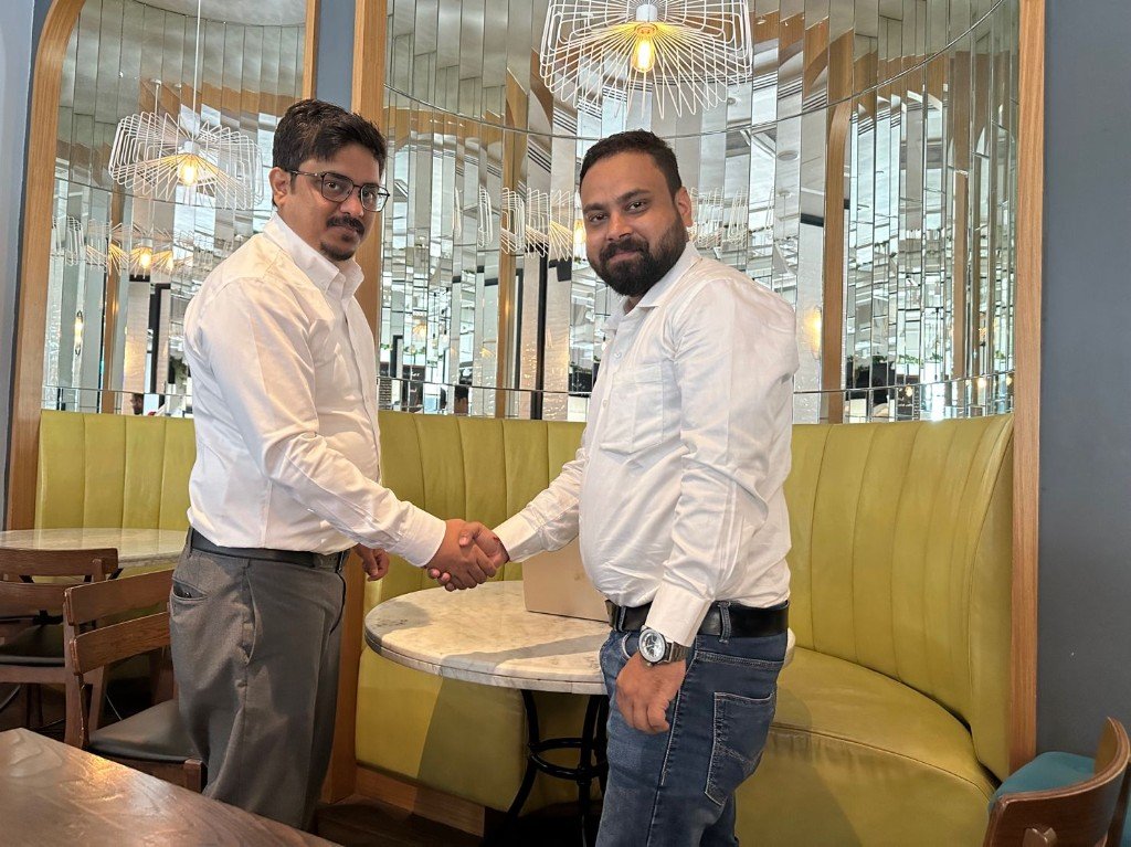 Softovate CTO Mayank Jain shaking hands with Solresol Technologies representative during a business meeting in Singapore
